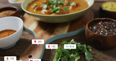 Showing blue-edged board topped by cilantro, resting on kitchen table with spice bowls and badges....
