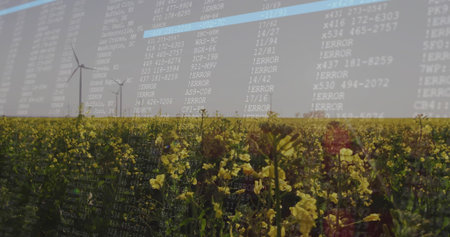 Combining canola field with translucent terminal text over rural farmland, showing wind turbines....