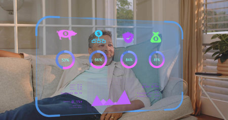 Reclining mature man in casual open shirt viewing AR finance dashboard on sofa, showing piggy bank....