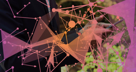 Tapping smartphone, man in dark suit and collared shirt at park, with pink orange network overlay....