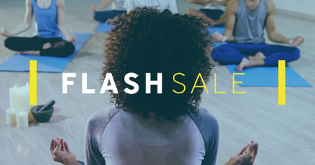 Sitting curly leader in gray top leading meditation at yoga studio, mats, white candles, FLASH SALE....