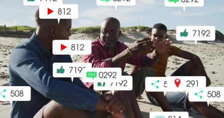 Talking senior in burgundy shirt and glasses, two men listening on sandy beach with social overlays....