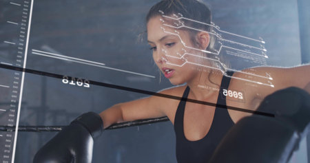 Leaning boxer wearing black sports bra and gloves, gripping top rope in boxing ring with HUD....
