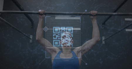 Pulling fit woman in blue sleeveless top gripping metal pull-up bar at gym, showing QR-code overlay....