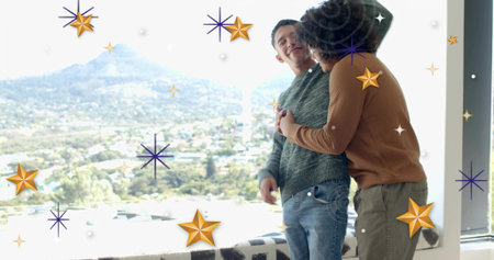 Embracing two men leaning at tall window, wearing sweaters and beanie, valley view, copy space....