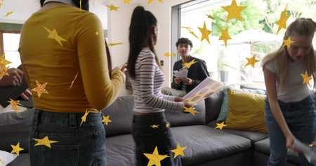 Reviewing friends passing print sleeves on gray sectional sofa in living room, golden stars. Group,...