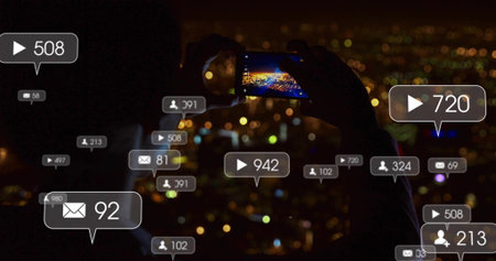 Silhouetted woman holding smartphone horizontally indoors at night, with floating overlay icons....