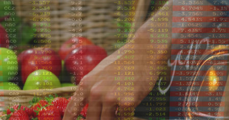 Reaching man wearing short sleeve selecting red strawberries at market with crates, stock overlay....