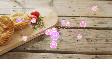 Displaying pink node network spreading across rustic wooden tabletop, with board pies tomatoes herb....
