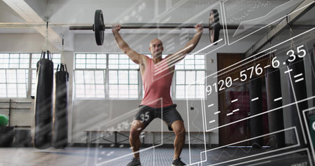 Lifting mid-adult man in red tank top holding loaded barbell overhead at gym, with AR readouts....