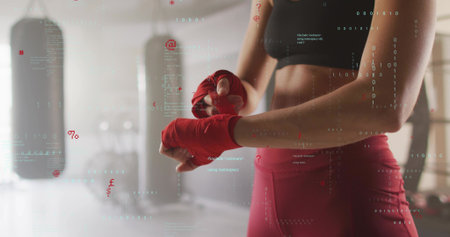 Wrapping boxer tying red hand wraps in boxing-gym, red-leggings, heavy bags, UI, copy space....