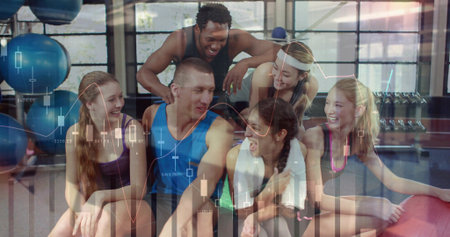 Sitting six friends in activewear on mats in gym with stability balls, dumbbells, financial overlay. Group, fitness, daylight, studio, social, wellness, financeの写真素材
