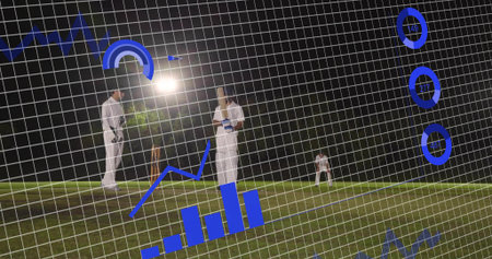 Standing white-clad batsman holding bat at night on grass pitch, with stumps and analytics overlay....