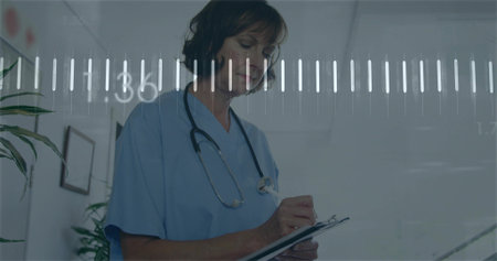 Writing nurse in blue scrubs taking notes on clipboard in clinic hall, stethoscope digital overlay....