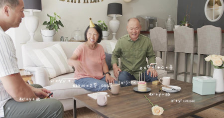 Celebrating family sitting at home coffee table, woman in pink top, party hat, lit cake, math....