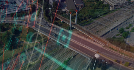 Showing multi-lane bridge with pylons carrying vehicles, spanning urban rail yard with data overlay....