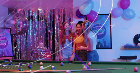 Smiling three women wearing red, orange, white tops with denim at pool table, disco ball....