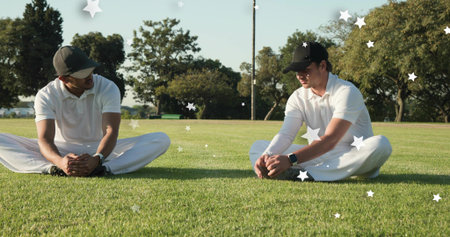 Stretching two male athletes leaning forward on sports field wearing white polos caps star overlays....