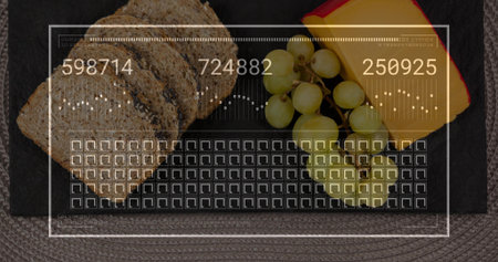 Arranging seeded bread, halved green grapes, cheese wedge red rind on slate at kitchen table HUD....