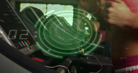 Left treadmill console projecting green HUD in home gym, bars, safety clip, pink bra, purple shorts....