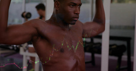 Pressing shirtless man using weight machine at gym, with mirrored wall, graph overlay. Fitness,...
