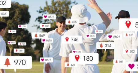 High-fiving group of four cricketers in white kit greeting on field, with notification overlays....