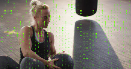 Sitting fit woman holding med ball on mat, black tank, bag shadow, green-binary overlay, copy space....