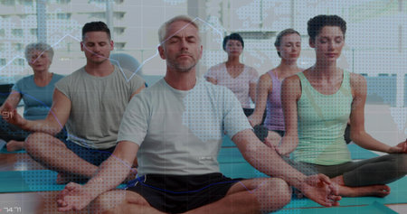 Meditating mature man crosslegged in fitness studio, in athletic wear, teal mats, data overlay....