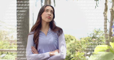 Standing woman in lavender zip-top, crossing arms, gazing upward in park with binary overlay, post....
