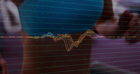 Female analyst wearing dark blue top touching glass display in lab, showing colored waveform traces....