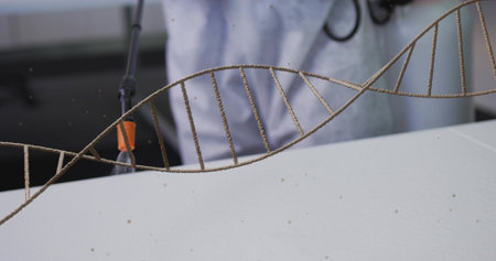 Showing double-helix model spanning foreground on white table, lab coat with stethoscope visible....