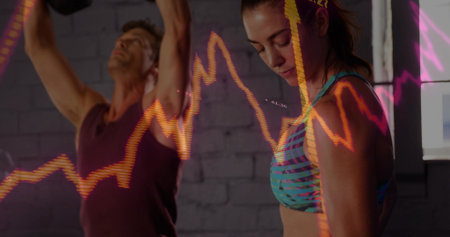 Stretching two adults in patterned teal bra and dark tank in studio with orange-pink line-chart....