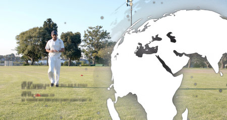 Walking player in whites and cap crossing grassy field, orange cones, world-map overlay, copy space....