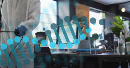 Cleaning tech in white suit, blue gloves using sprayer on DNA-decal glass at office, copy space....