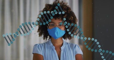 Standing woman wearing clear glasses, blue mask and light-blue pleated blouse in room, DNA overlay....