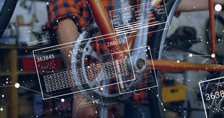 Inspecting mechanic in orange plaid shirt adjusting bicycle crankset and chain in workshop, HUD....