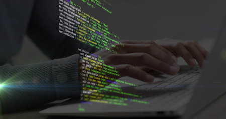 Developer's hands typing laptop keyboard, initiating diagonal green code overlay, building software....