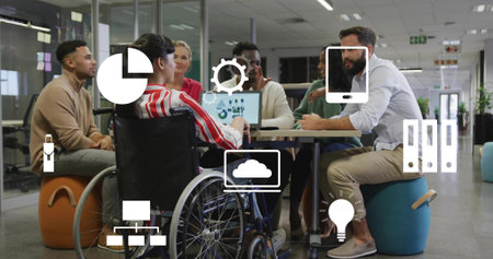 Talking six team in casual dress checking laptop in office showing wheelchair and digital icons....