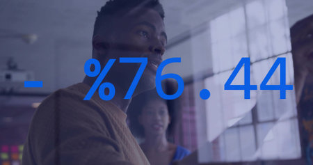 Examining team reviewing glass wall at office, male brown sweater, female blue top, %76.44 overlay....