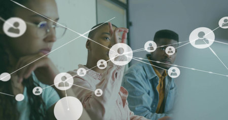 Reaching central woman in ruffle blouse interacting with virtual user icons in small office, laptop....
