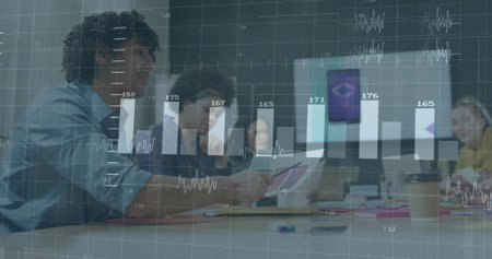 Left woman reviewing charts at table, peer pointing causing bar chart overlaying business metrics....