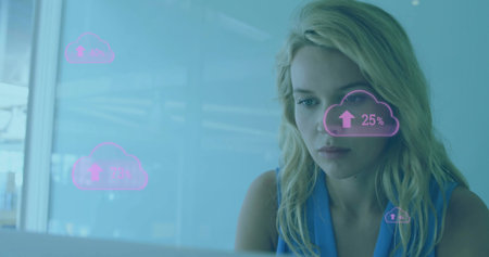 Working woman in sleeveless blue top analyzing laptop metrics in office with cloud UI, copy space....