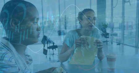 Two peers at business cafe woman eating during lunch while charts overlaying glass highlighting bag....