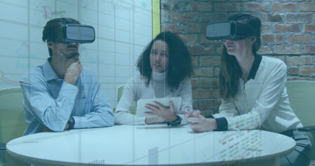 Holding tablet center woman guiding colleagues wearing VR headsets in modern office with whiteboard....