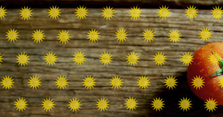 Displaying framed ripe red tomato sitting on wooden plank, with yellow sunburst grid, copy space....