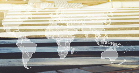 Displaying pedestrian crosswalk showing light and dark stripes at curb, with world map overlay....