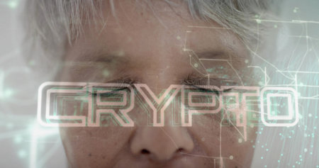 Displaying closeup senior woman eyes closed gray hair in studio, showing CRYPTO text and circuit....