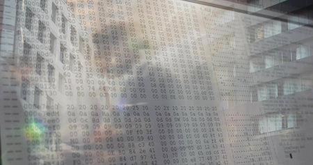 Displaying translucent display showing hexadecimal dump in office atrium with reflected facade....