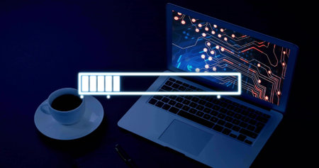 Displaying open silver laptop showing circuit motif on blue desk, loading bar, coffee cup and pen....