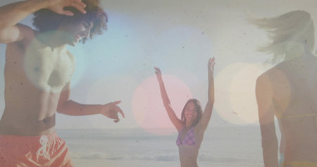 Gesturing shirtless man and bikini woman raising arms at sandy shore, lens flare on swimwear. Beach,...